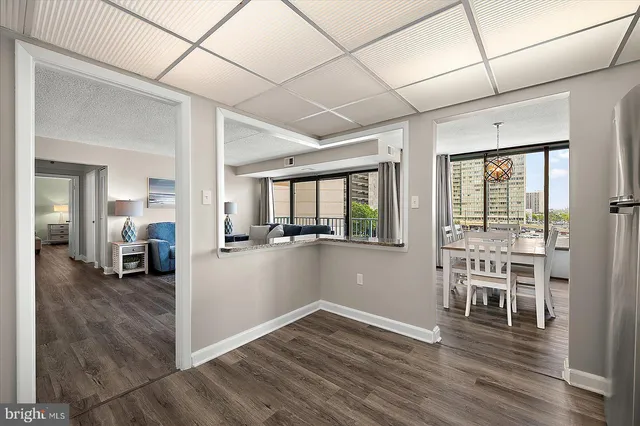 a view of a livingroom with wooden floor and furniture