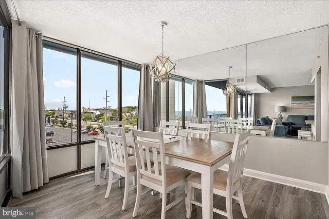 a very nice looking dining room with furniture window and wooden floor