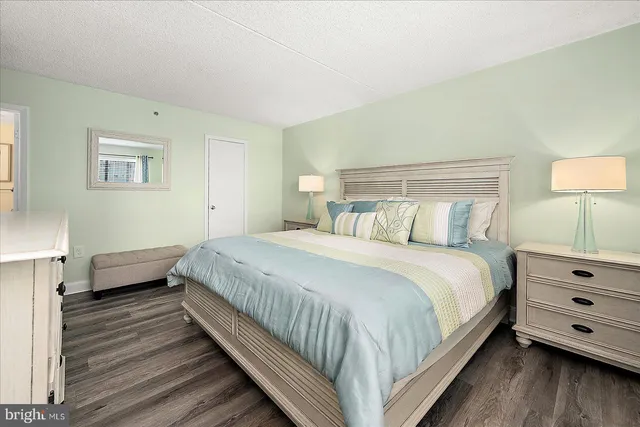 a bedroom with a bed and a night stand