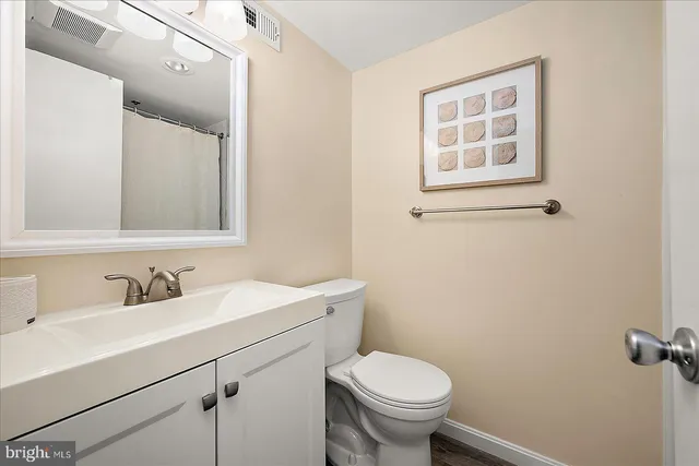 a bathroom with a sink toilet and mirror