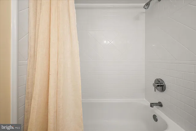 a bedroom with two beds and wooden floor