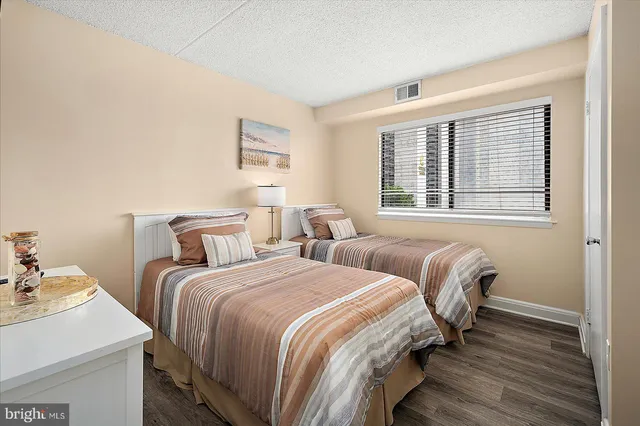 a bedroom with two beds and a television