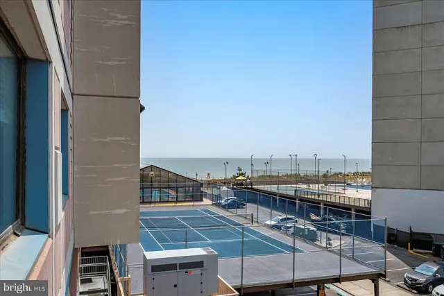 a view of a roof deck with table and chairs a barbeque