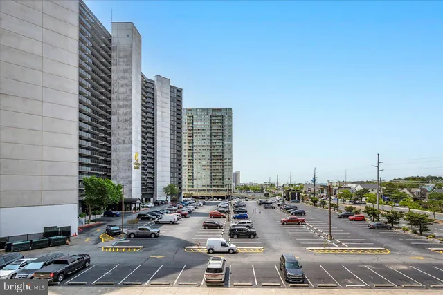 a view of a balcony with wooden floor and fence