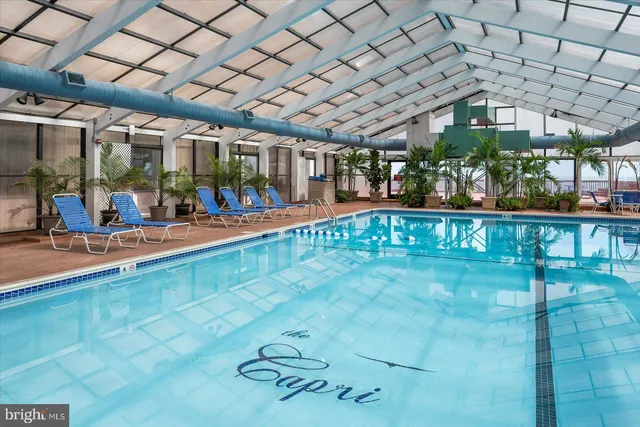 a living room with furniture and a dining table with wooden floor