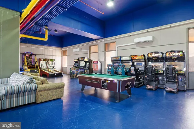 a living room with furniture and a book shelf