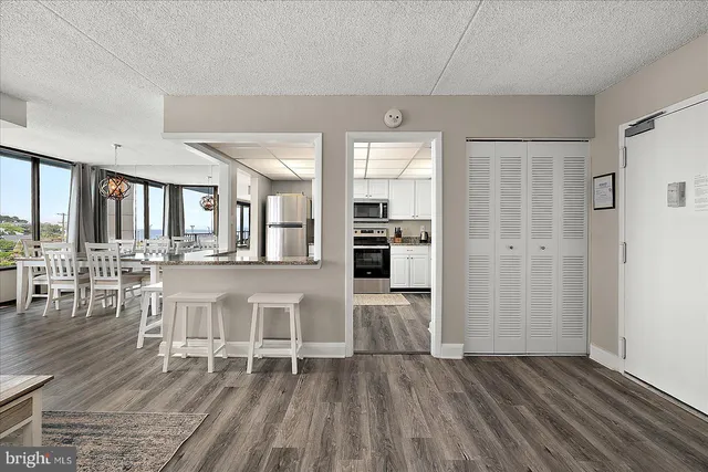 a view of a livingroom with wooden floor and furniture
