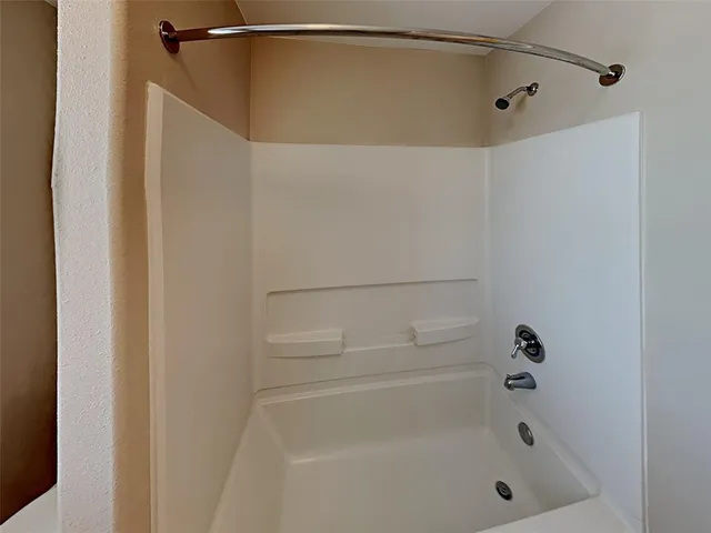 a bathroom with a shower and a bath tub