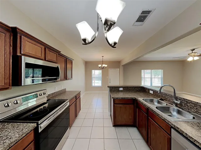 a kitchen with a stove and a sink