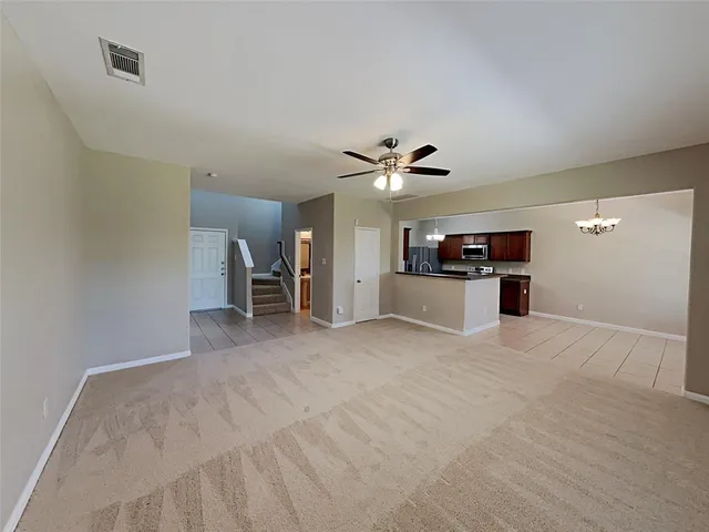 a view of a kitchen with a sink and a refrigerator