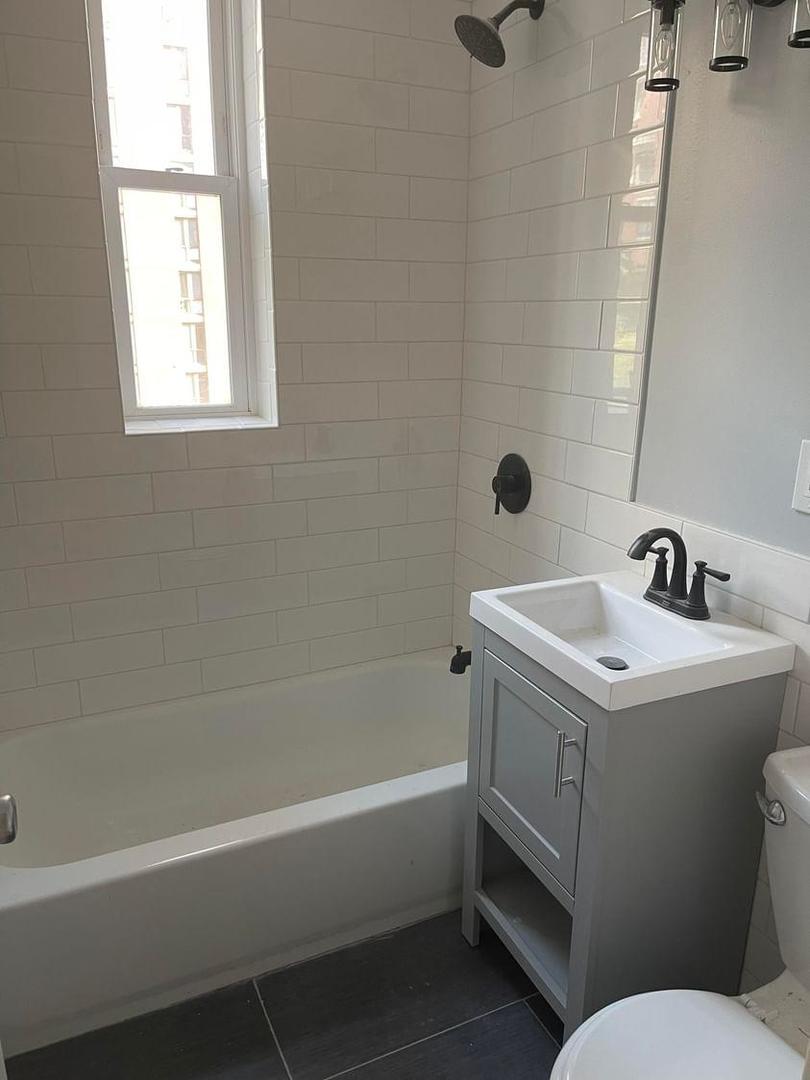 67 West Chestnut Street, Unit 4 Chicago, IL 60610 - Photo 12 of 13 a bathroom with a sink and a bathtub