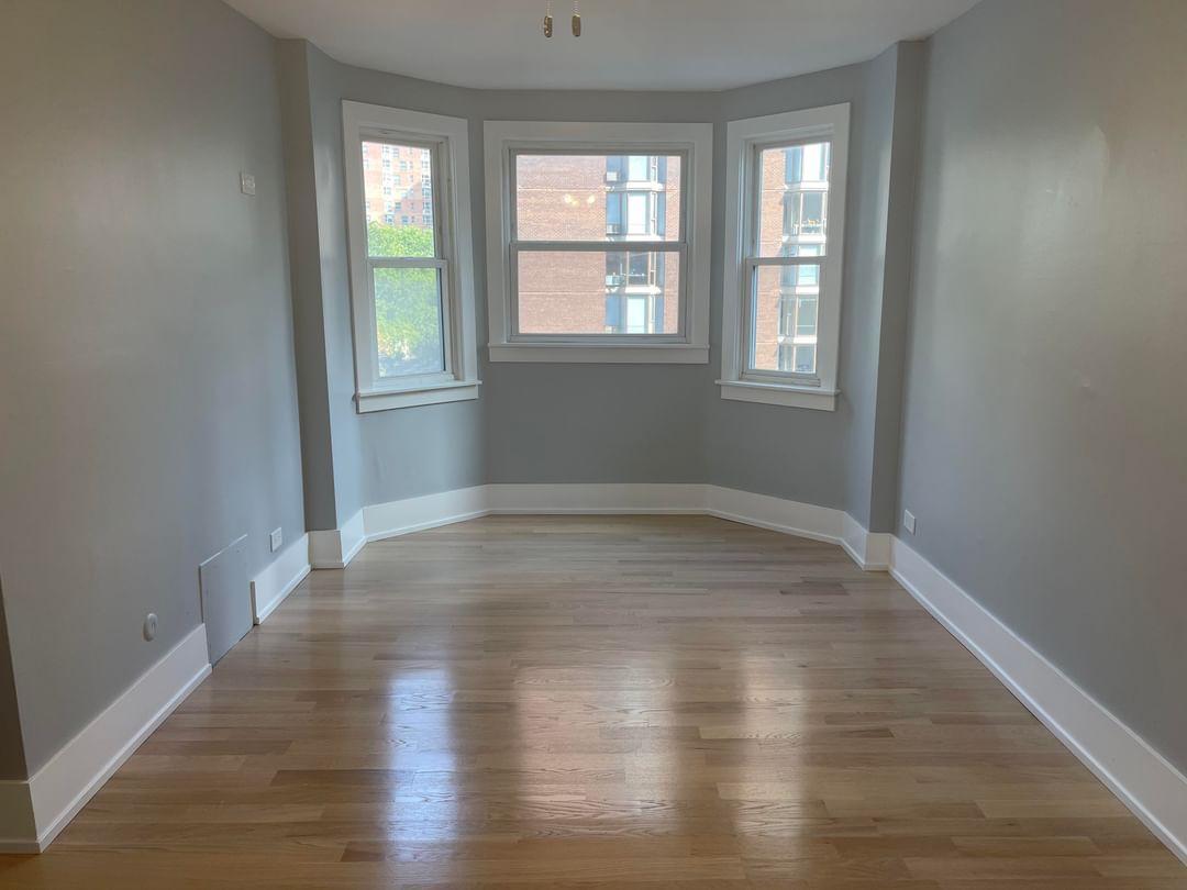 67 West Chestnut Street, Unit 4 Chicago, IL 60610 - Photo 3 of 13 wooden floor in an empty room with a window