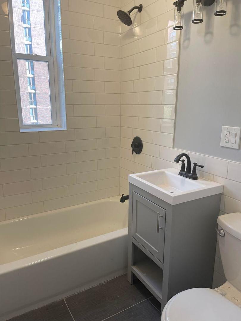 67 West Chestnut Street, Unit 4 Chicago, IL 60610 - Photo 8 of 13 a bathroom with a sink a toilet and shower