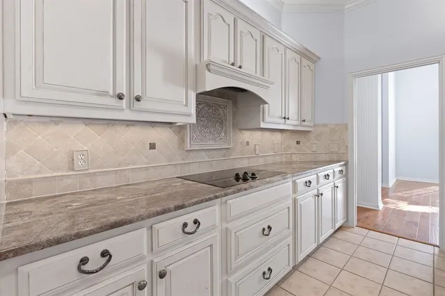 a kitchen with granite countertop white cabinets stainless steel appliances and sink