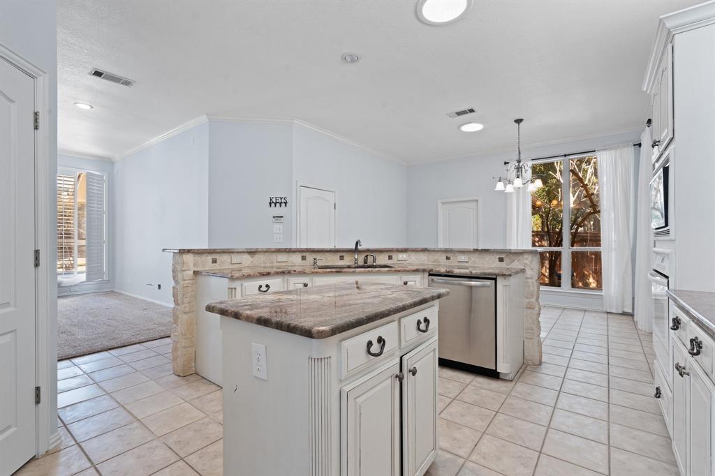 4 Brookway Court Mansfield, TX 76063 - Photo 12 of 38 a kitchen with a sink stove and cabinets
