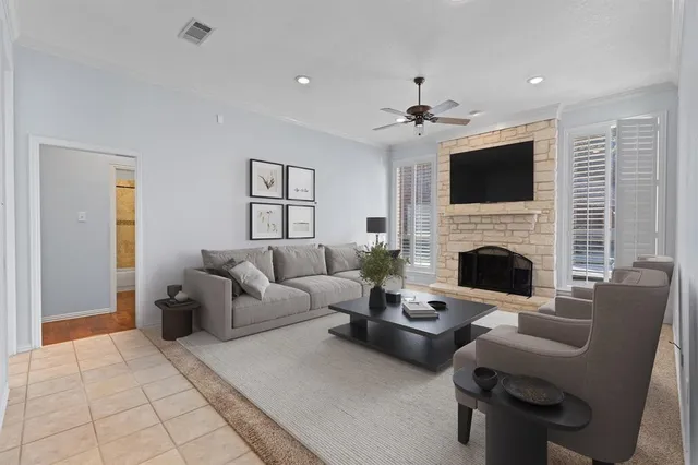 a living room with furniture a flat screen tv and a fireplace