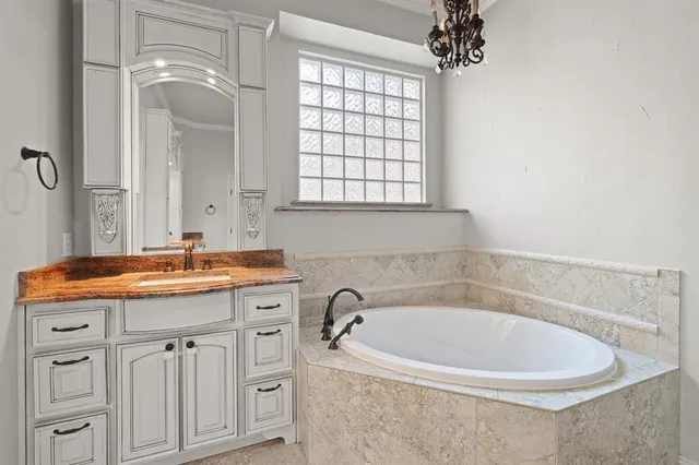 a bath room with a sink and a mirror
