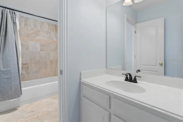 a bathroom with a sink and a shower