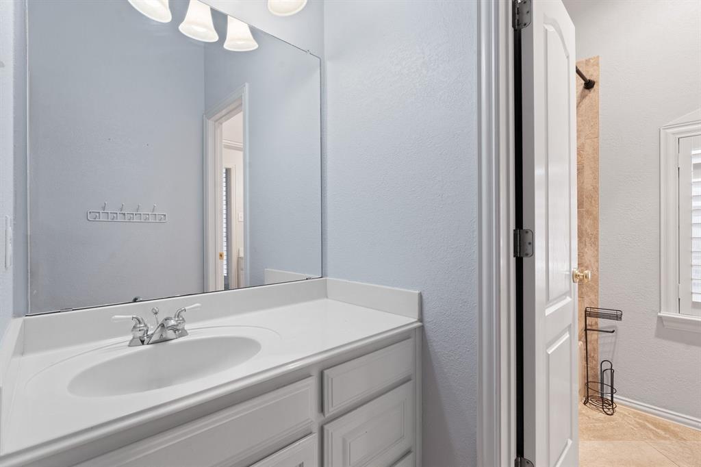 4 Brookway Court Mansfield, TX 76063 - Photo 29 of 38 a bathroom with a sink and a mirror