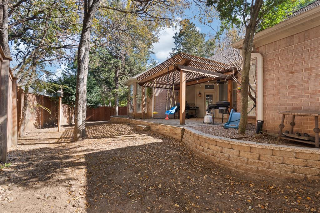 4 Brookway Court Mansfield, TX 76063 - Photo 37 of 38 a view of a house with backyard and trees