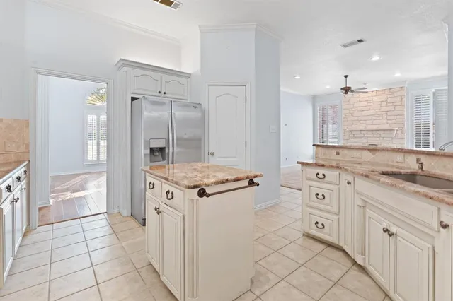 a kitchen with granite countertop a sink stove and cabinets