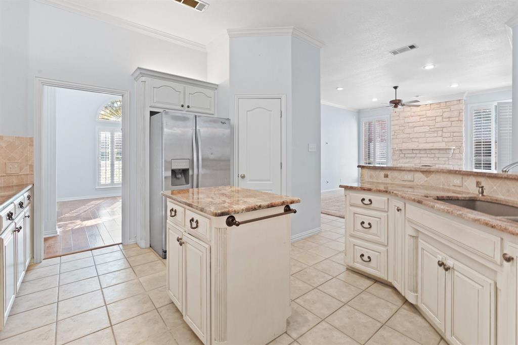 4 Brookway Court Mansfield, TX 76063 - Photo 9 of 38 a kitchen with granite countertop a sink stove and cabinets