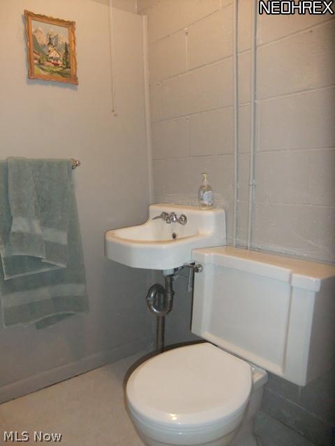 244 Winchester Road Akron, OH 44333 - Photo 17 of 21 Half bathroom in the lower level features neutral decor.