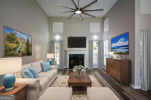 a living room with furniture a fireplace and a flat screen tv