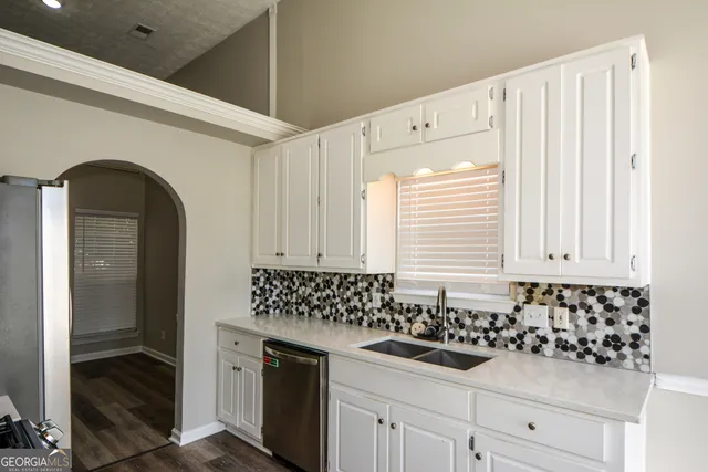 a kitchen with a sink and cabinets