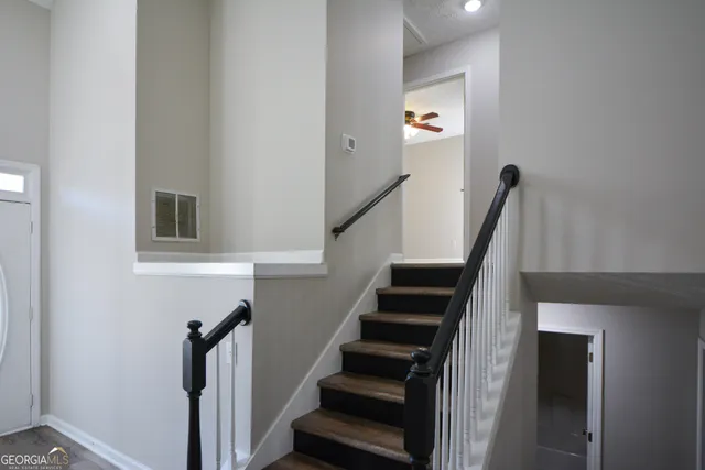 a view of entryway and hall with wooden floor