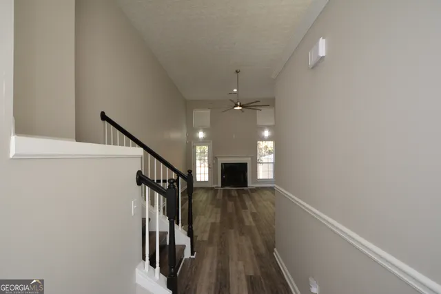a view of entryway and hall with wooden floor