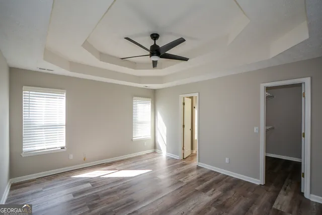 a view of a livingroom with a ceiling fan and window