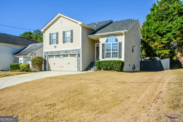 a view of a house with a yard and garage
