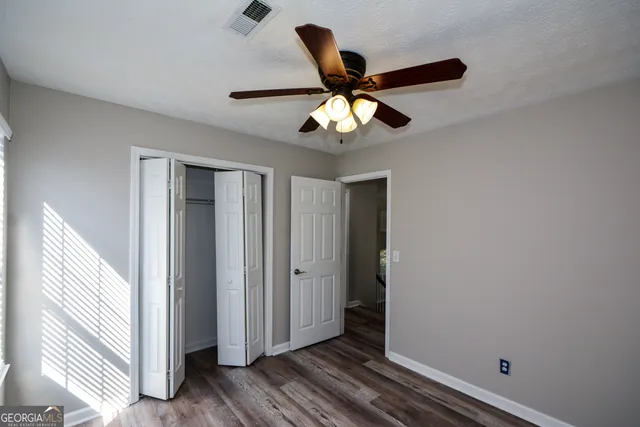 a view of a chandelier fan and closet
