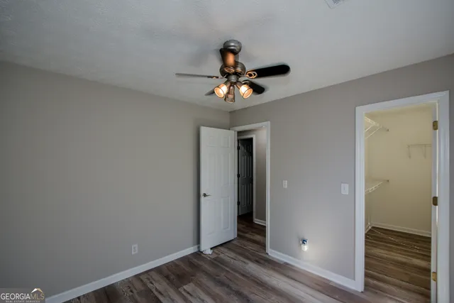 a bathroom with a bathtub shower sink vanity and mirror