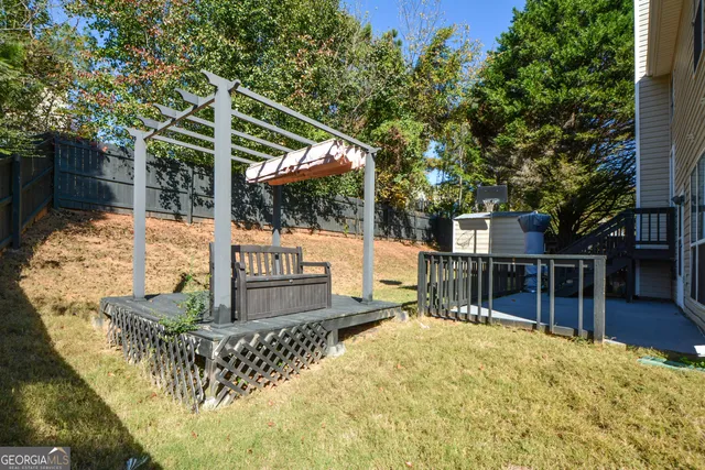 a balcony with wooden floor stairs and furniture