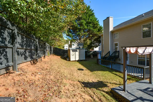 a view of a backyard with large trees