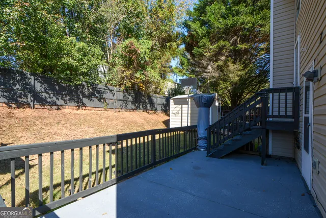 a view of a house with a wooden deck
