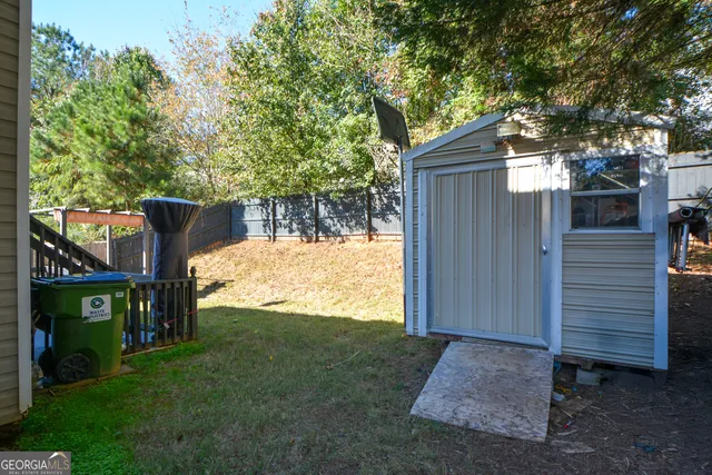 a view of a house with backyard and deck