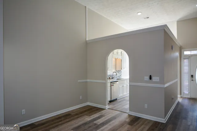 a room with a wooden floor and entryway