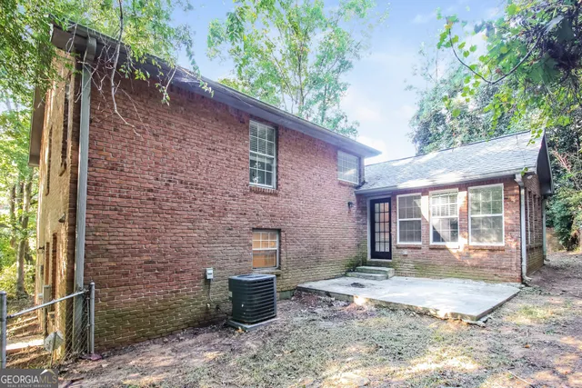 a backyard of a house with yard and outdoor seating