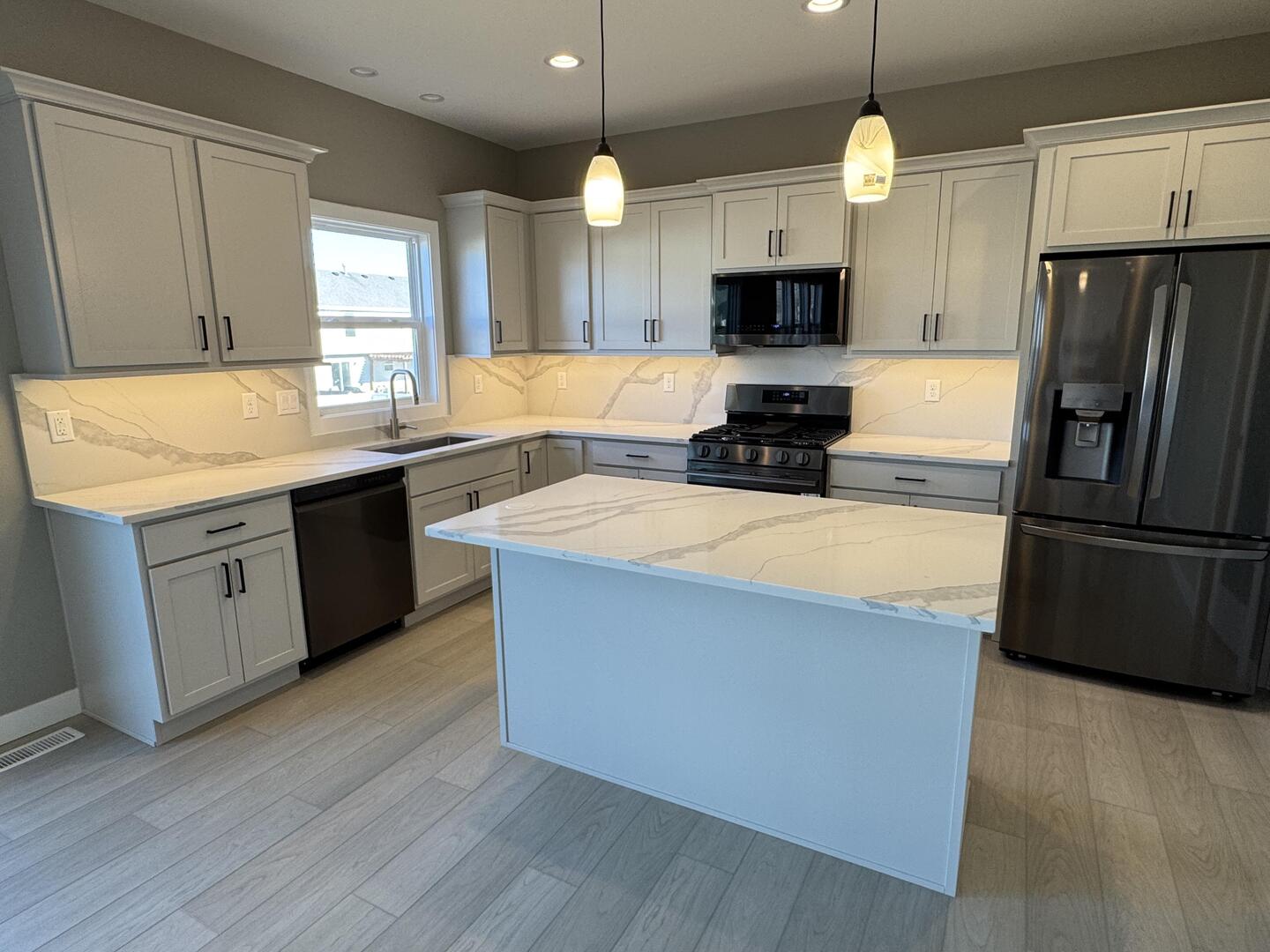 3618 Cabernet Court Normal, IL 61761 - Photo 12 of 16 a kitchen with stainless steel appliances a stove top oven a sink and a refrigerator