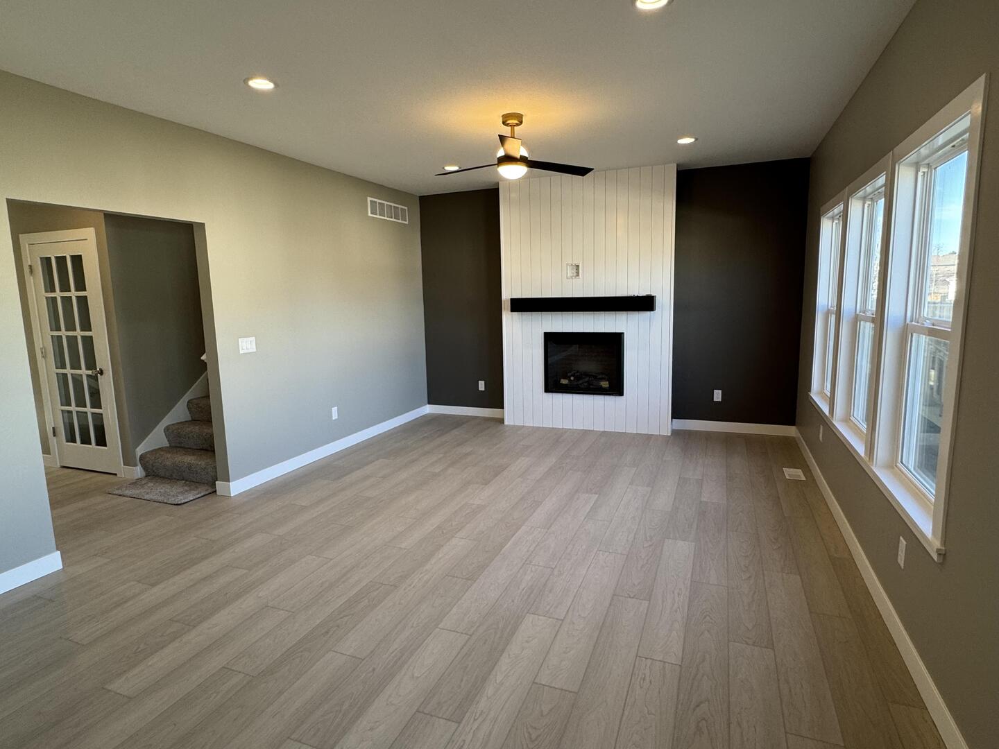 3618 Cabernet Court Normal, IL 61761 - Photo 10 of 16 an empty room with wooden floor a fireplace and entryway