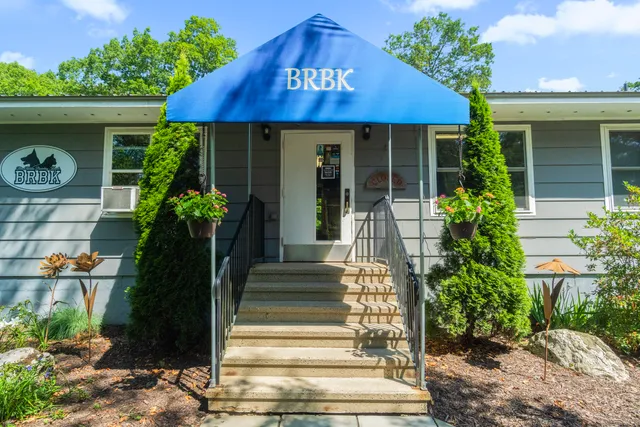 a front view of a house with plants
