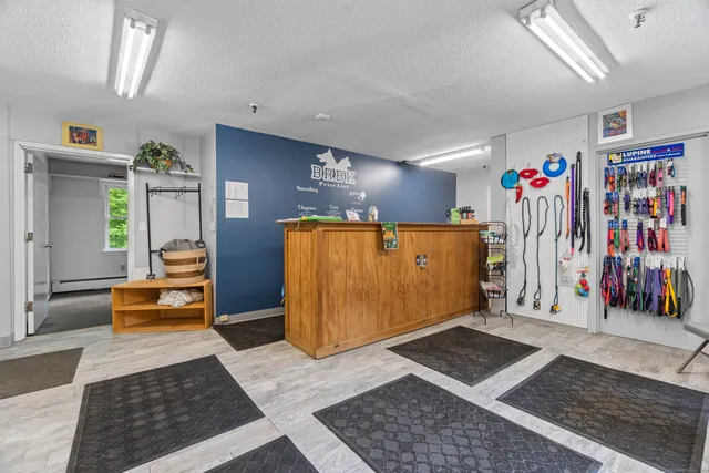 a view of a hallway with a couch and dresser