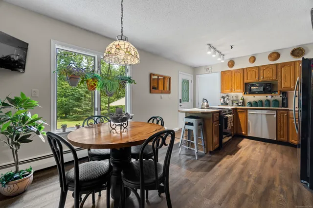 a view of a dining room with furniture window and wooden floor
