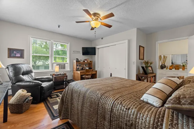 a bed room with a bed and a large window