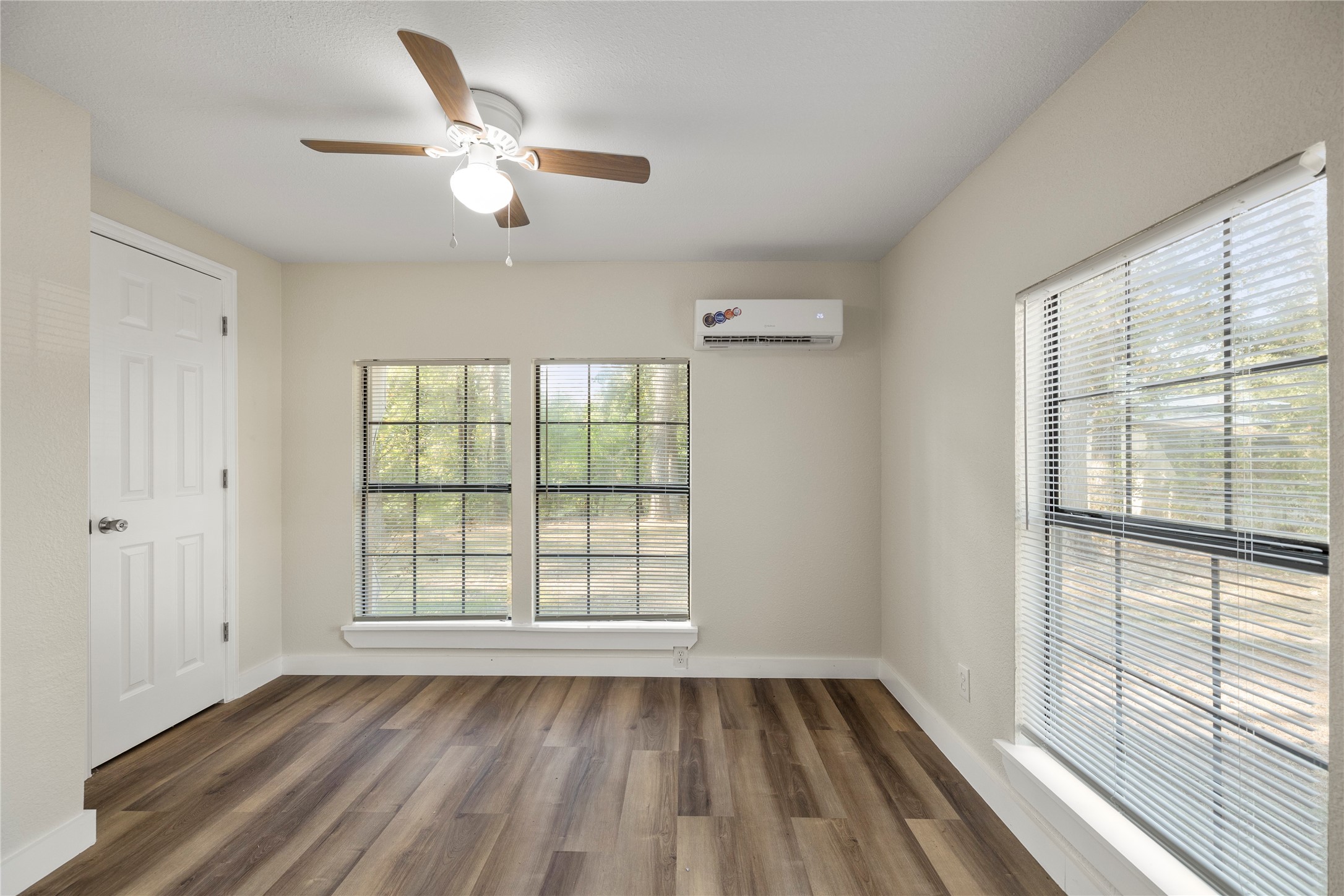 37111 Middle Trail, Unit 1 Magnolia, TX 77354 - Photo 12 of 32 a view of an empty room with a window and wooden floor
