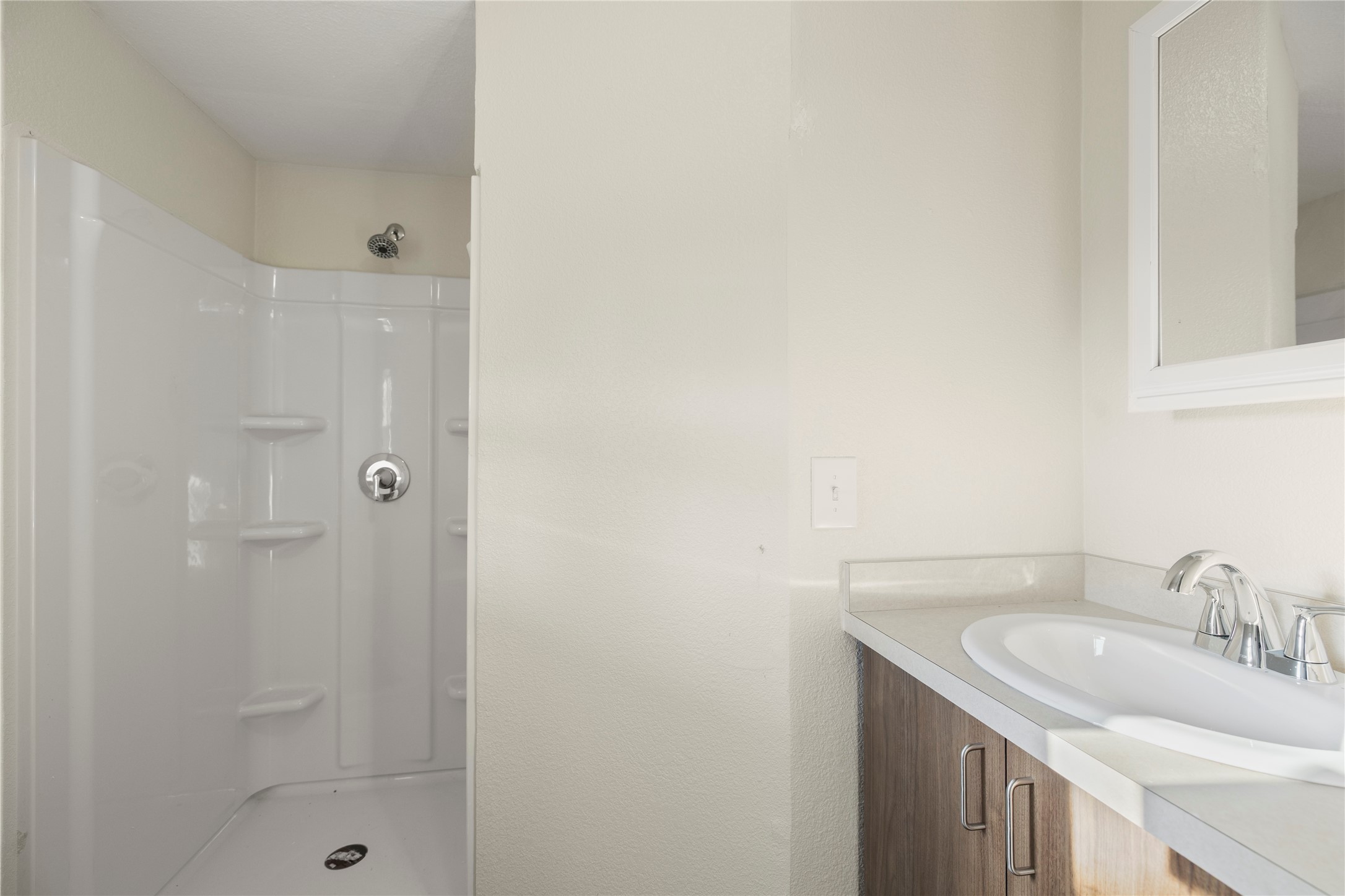 37111 Middle Trail, Unit 1 Magnolia, TX 77354 - Photo 16 of 32 a bathroom with a granite countertop sink a shower and a mirror