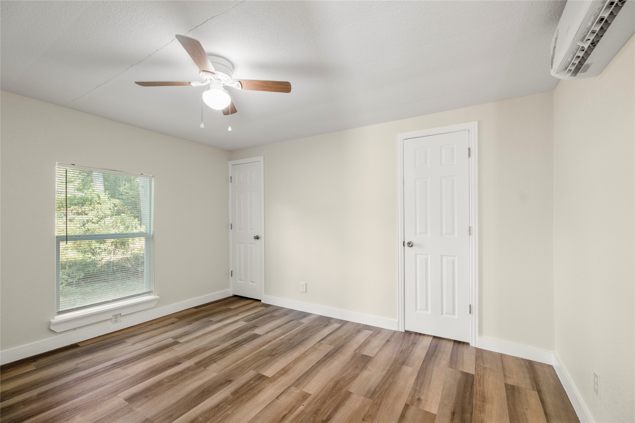 37111 Middle Trail, Unit 1 Magnolia, TX 77354 - Photo 18 of 32 an empty room with wooden floor fan and windows